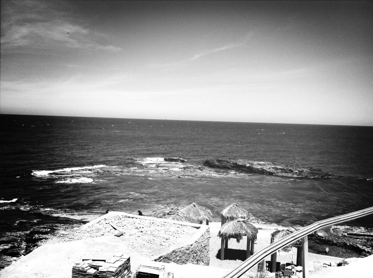 sea, horizon over water, water, scenics, sky, beach, tranquil scene, tranquility, beauty in nature, high angle view, nature, shore, built structure, idyllic, rock - object, coastline, day, outdoors, seascape, architecture