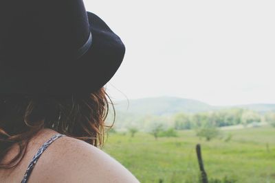 Rear view of woman looking at field in foggy weather