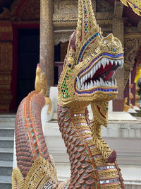 Low angle view of statue against temple building