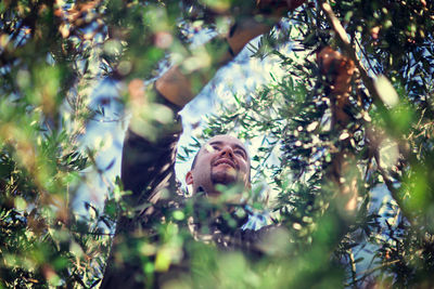 Low angle view of man see through plants