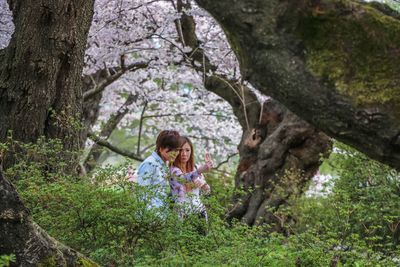 Girl playing with tree