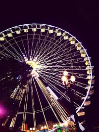 Low angle view of ferris wheel at night