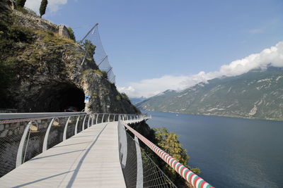 Bridge over mountain against sky