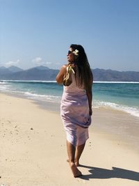 Full length of woman standing on beach