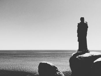 Woman standing by sea