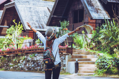 Woman standing outside house