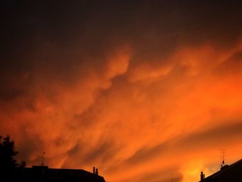 Silhouette of tree against cloudy sky