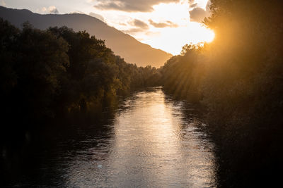 Scenic view of river against sky during sunset