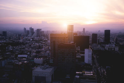 High angle view of buildings against sky during sunset