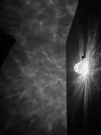 Low angle view of illuminated light bulb at night