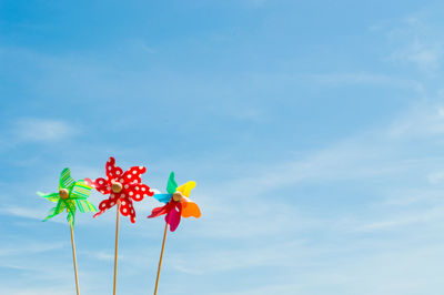 Close-up of colorful pinwheel toys against sky