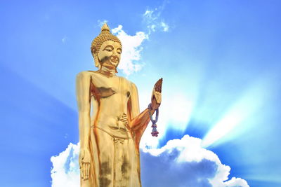 Low angle view of statue against blue sky