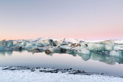 Scenic view of frozen lake against sky during winter