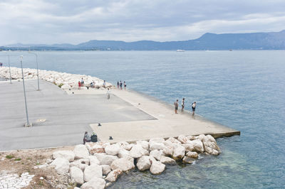 People on beach against sky