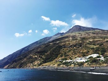 Scenic view of sea and mountains against sky