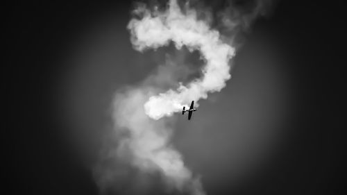 Low angle view of airplane flying in sky