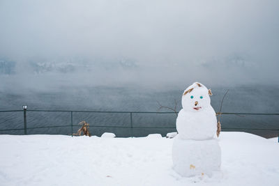 Snowman on snow covered land