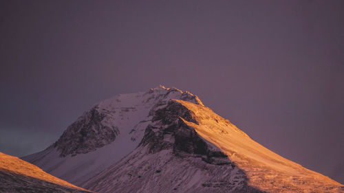 Scenic view of snowcapped mountains against clear sky