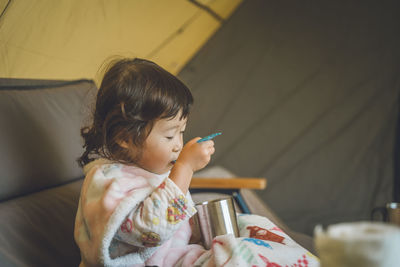 Young woman using spoon