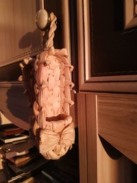 Close-up of sculpture hanging on wooden door