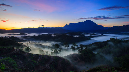 Scenic view of mountains against sky during sunset