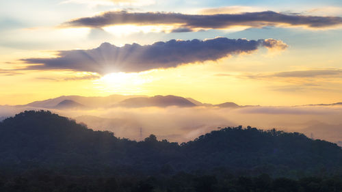 Scenic view of silhouette mountains against sky at sunset