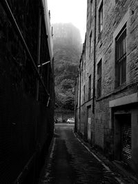 Narrow alley amidst buildings in city