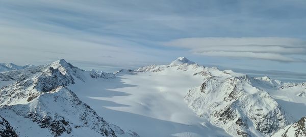 Scenic view of snow covered mountains against sky