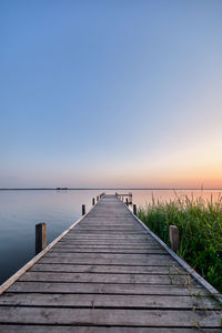 Pier over sea against clear sky