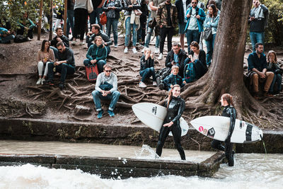 Group of people sitting by the road