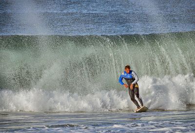 People surfing in sea