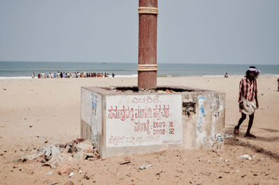 View of text on beach against clear sky