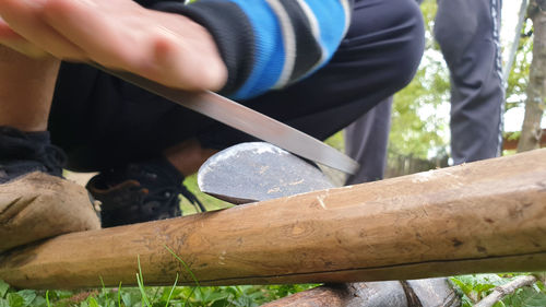 Midsection of man holding wood