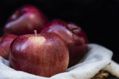 Close-up of apple on table against black background