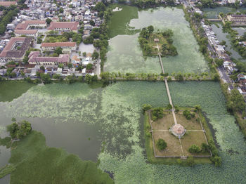 High angle view of fountain by lake against building