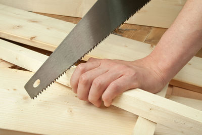 Close-up of man working on hardwood floor