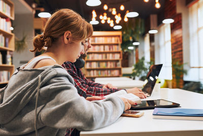 Students learning in university library. preparing for test. learning on computer. back to school