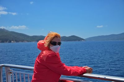 Senior woman with medicine mask on the boat