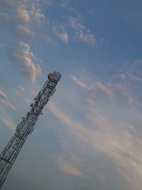 Low angle view of crane against cloudy sky