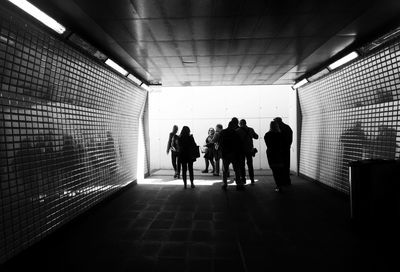 Group of people walking in tunnel