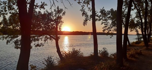 Scenic view of lake against sky during sunset