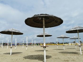 Umbrellas on beach against sky