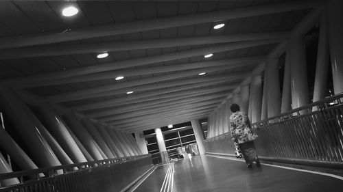 Rear view of people walking in corridor