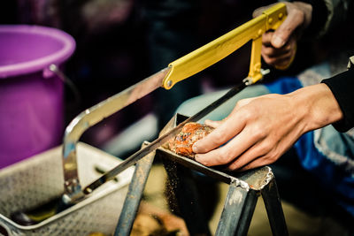 Midsection of person preparing food on barbecue grill