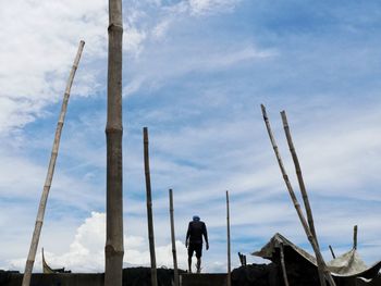 Low angle view of person standing on land against sky