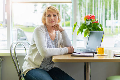 Woman sitting on chair at table