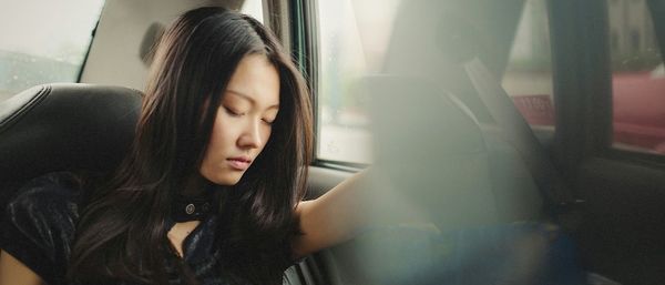 Rear view of woman sitting in train