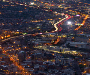 High angle view of city lit up at night