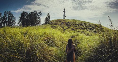 Scenic view of grassy field against sky