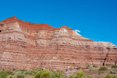 Low angle landscape of striped stone hillside at the toadstools in grand staircase escalante in utah
